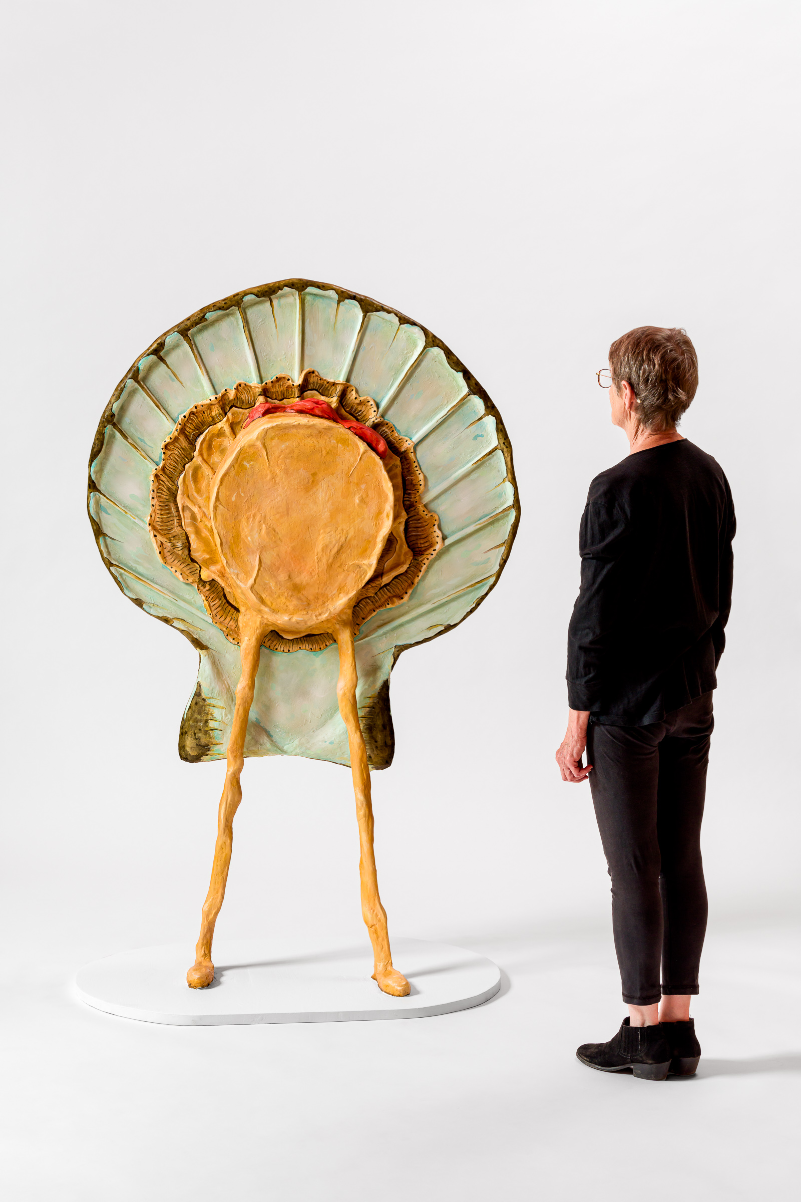 sculpture of a shucked scallop standing on legs