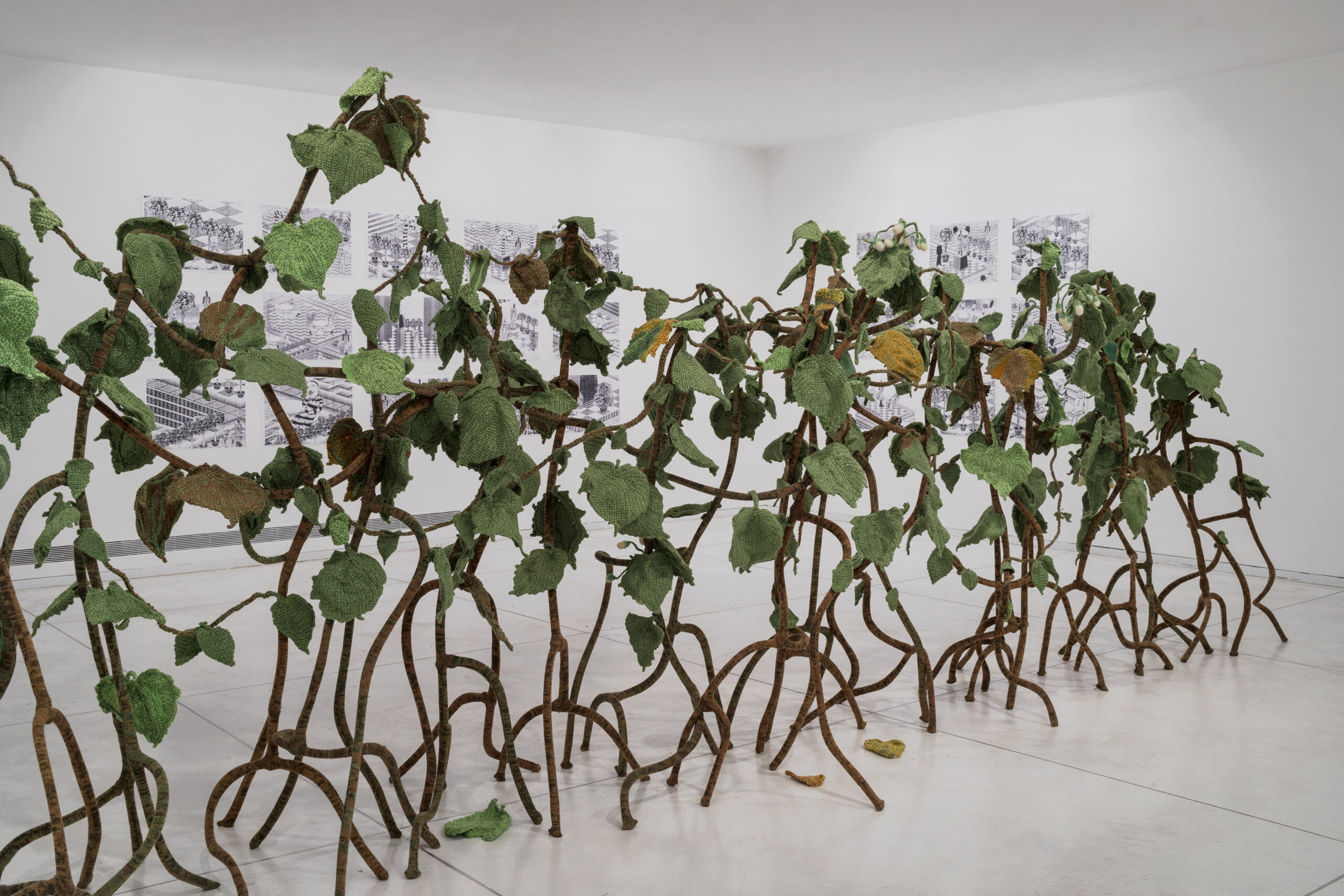 This knitted Hedgerow was created in collaboration with Kuchinate collective - a collective of African Women asylum seekers in Israel who knit for their living, along with 265 volunteers. It reflects on an archival document from 1944 in which the commander of Auschwitz ordered his troops to create a hedgerow which will cover the gas chambers of the camp.