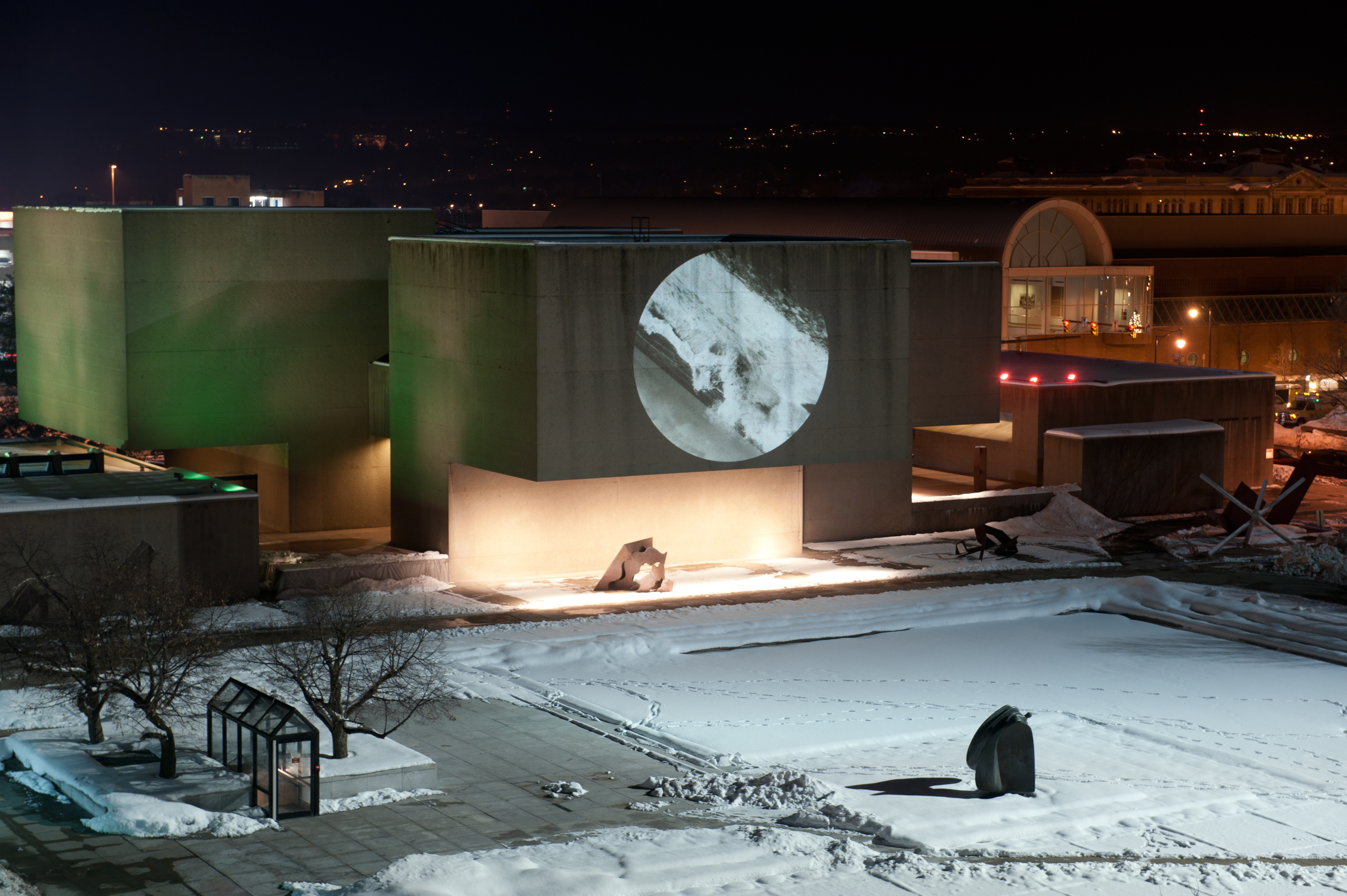 Projected onto the exterior of the Everson Museum in Syracuse, New York, this video depicts a still image of a crashing wave constantly turning in the ocean. The movement of the video speaks to the rotation of the moon and its gravitational effect on tides.