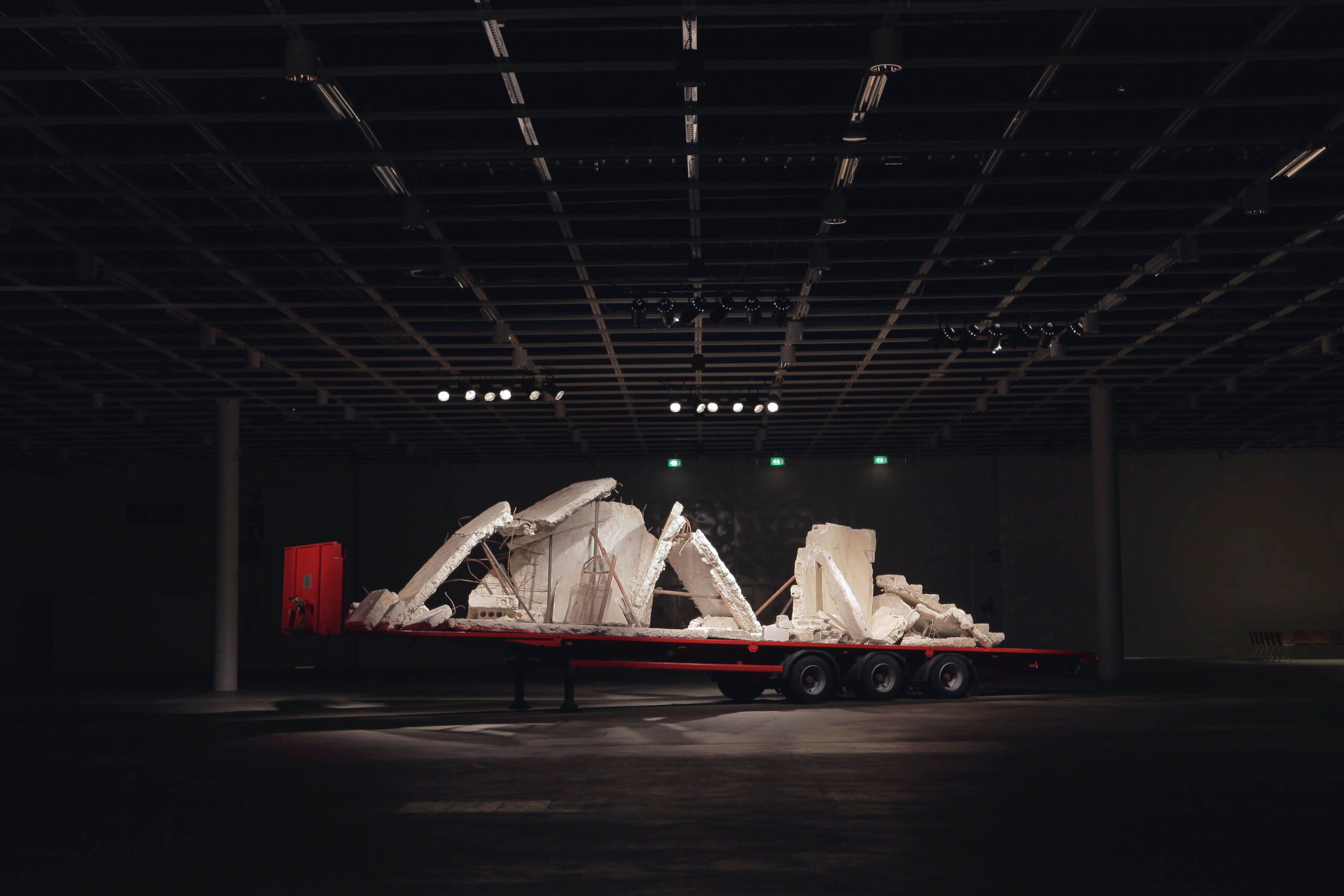 Ruins of a bombed house, transported from Syria, assembled on a flatbed in order to be transported and driven from place to place, as a temporary arrangement.