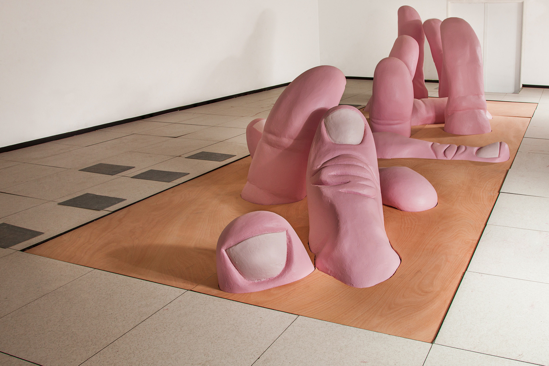 11 large scale pink thumbs sunk into the floor in a composition influenced by Raft of the Medusa by Theodore Jericho