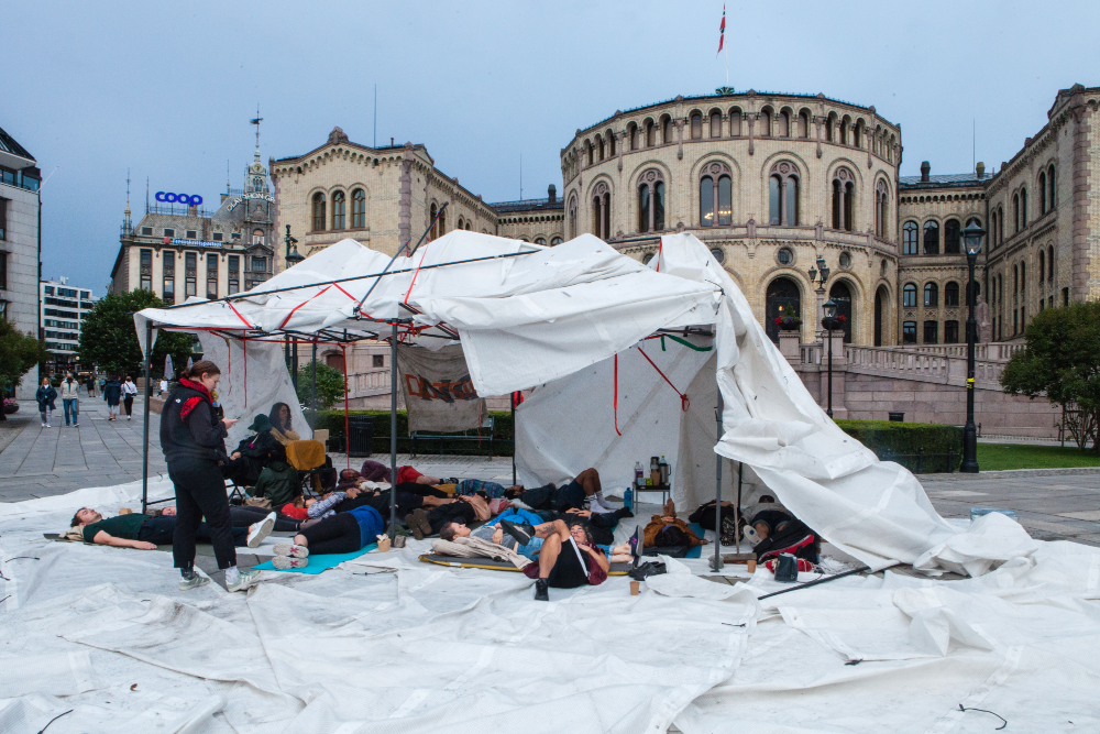 Gathering in front of parlament of Oslo, as protest, assembly, practicing collective nap.