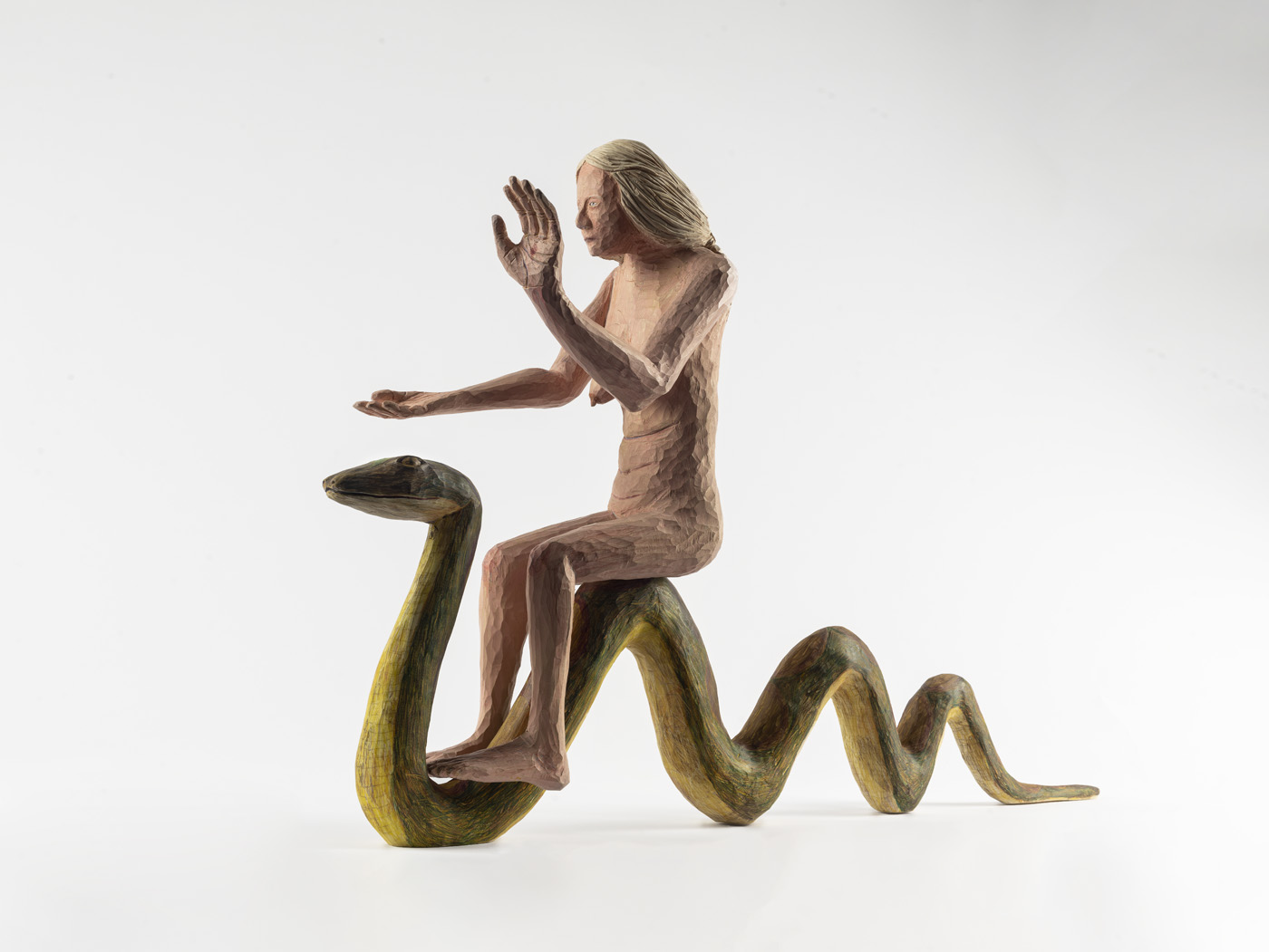 Female figure with blonde hair riding a green snake
