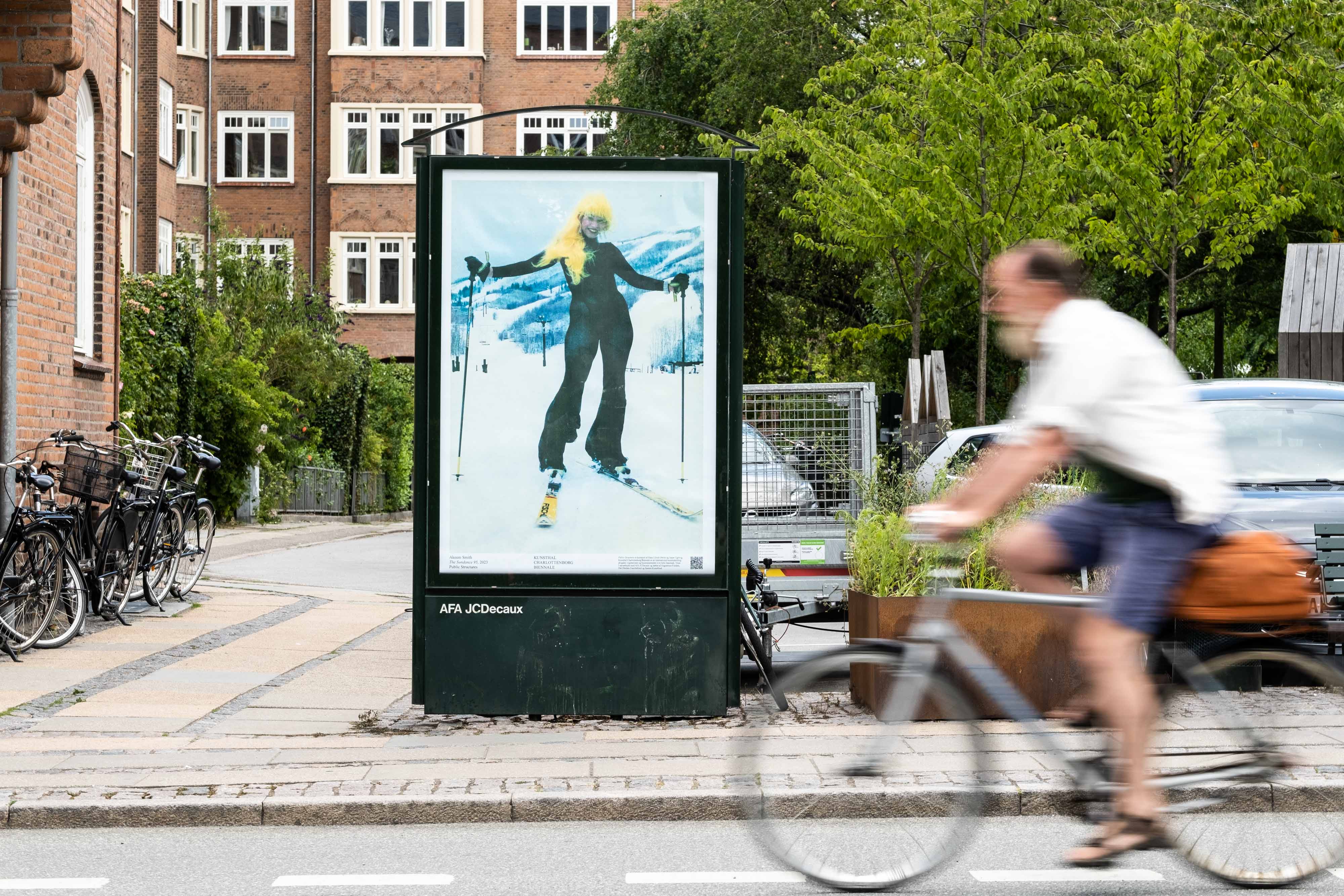 A billboard featuring a woman posing on a skiing slope.