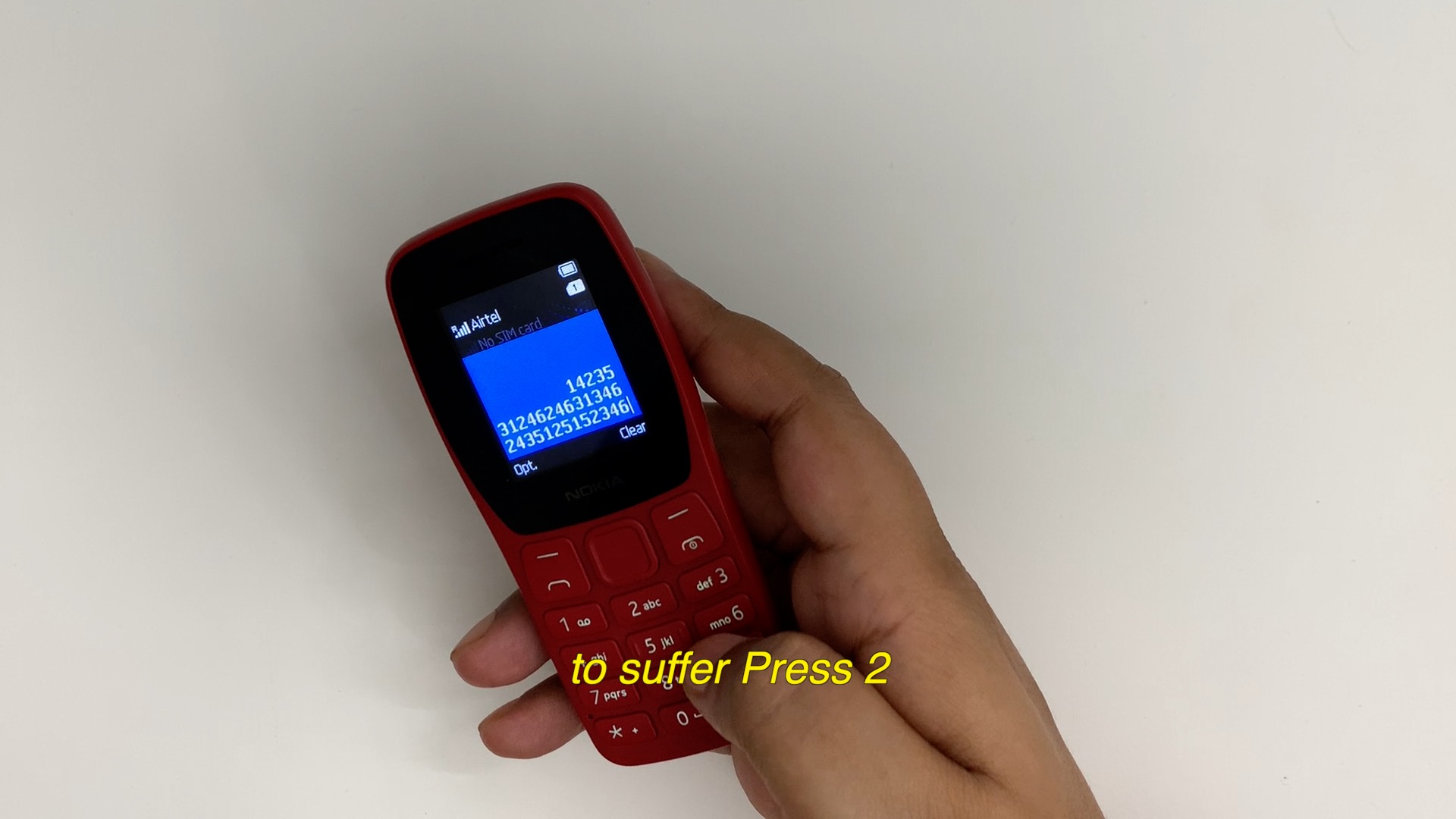 A hand presses numbers on a mobile phone to navigate an unknown (to the listener) structure of speech made of unrelated or related meanings.