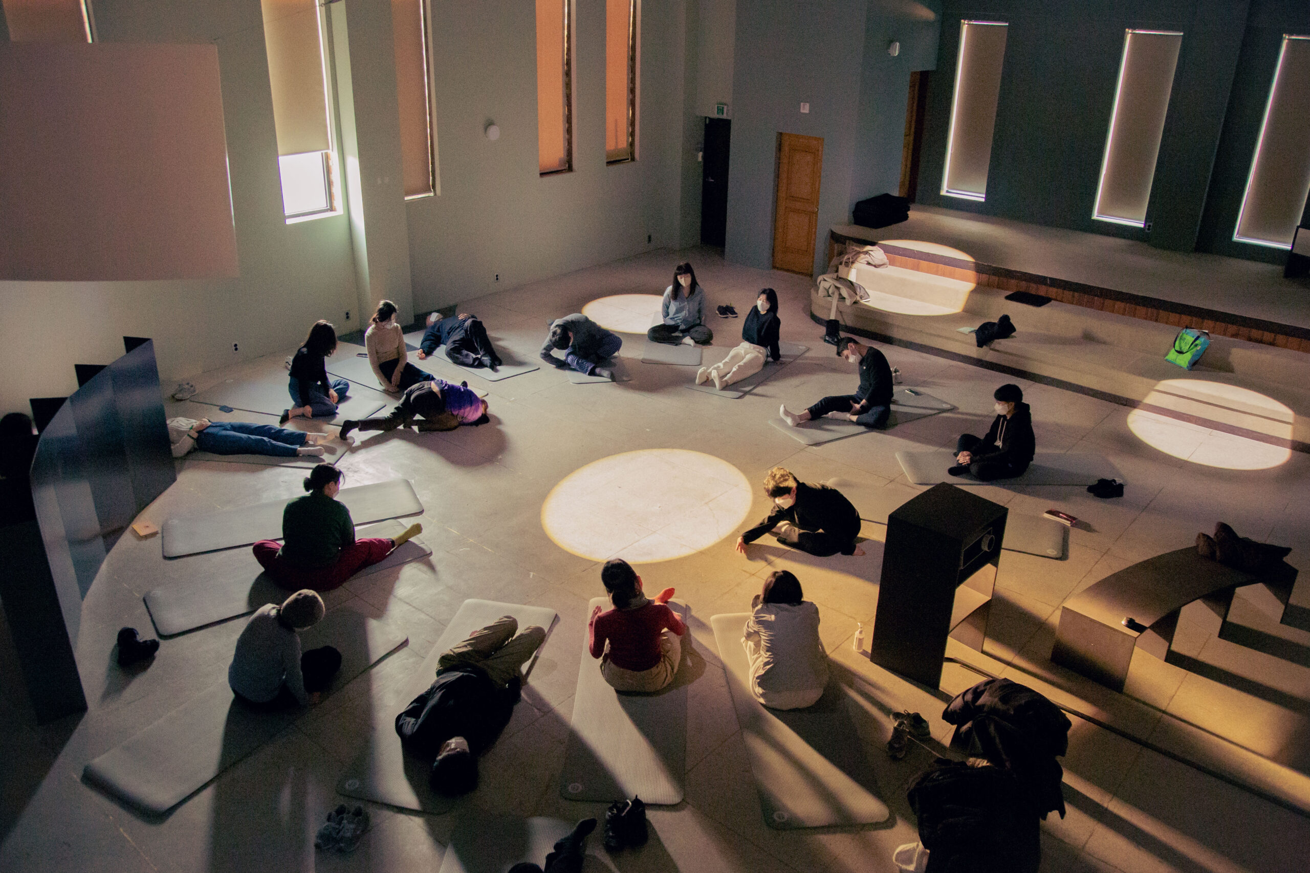 Group of people are doing octopus yoga performance together