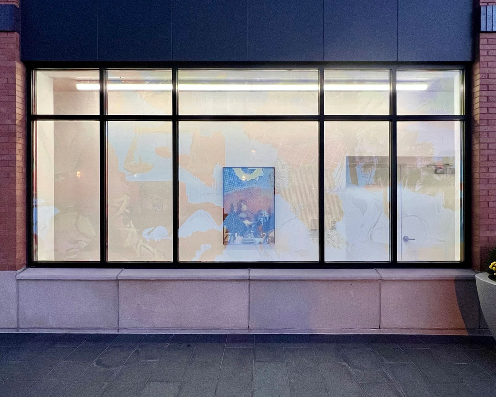 A view of the same artwork in the first image, but this time showing the installation as it appears right after sun set. The vinyl become transparent as the light inside the window display become brighter than the sunlight outside. The saturated image becomes more subdued to reveal the framed artwork hanging on the wall behind the window.