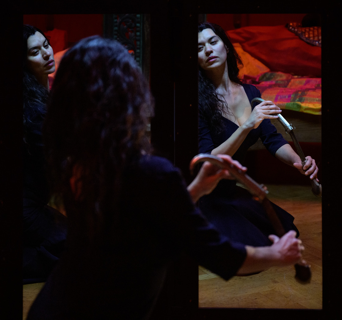 The work is based on the history of western art, where especially binarity was represented and depicted, which for this performance can create discomfort, as only binary division principles are used among the audience. In the work ODALISQUE the audience travels into the artist Lina Hashim’s work as a female artist with a Muslim cultural background. At the same time, the audience is also taken into the Western, white art history, where the portrayed brown woman is often portrayed as the odalisque; a mute, seductive, female slave in a harem. Through this work, Hashim wants to redefine the story that has been told through art history and create a space for retelling the cemented ideology of the erotic harem. Hashim is interested in the representation of the odalisque figure in Western painted art, particularly during the period of Orientalism, as a masculine colonial construct, and the contemporary ideas of liberation and rescue of the same woman.